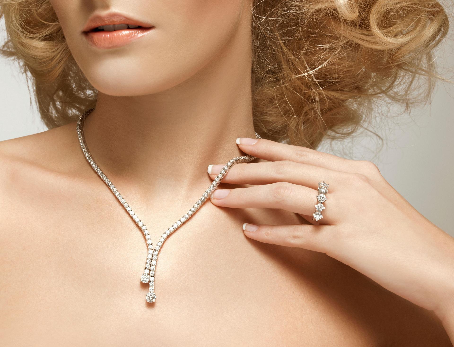 Young beautiful woman portrait with a diamond ring and necklace