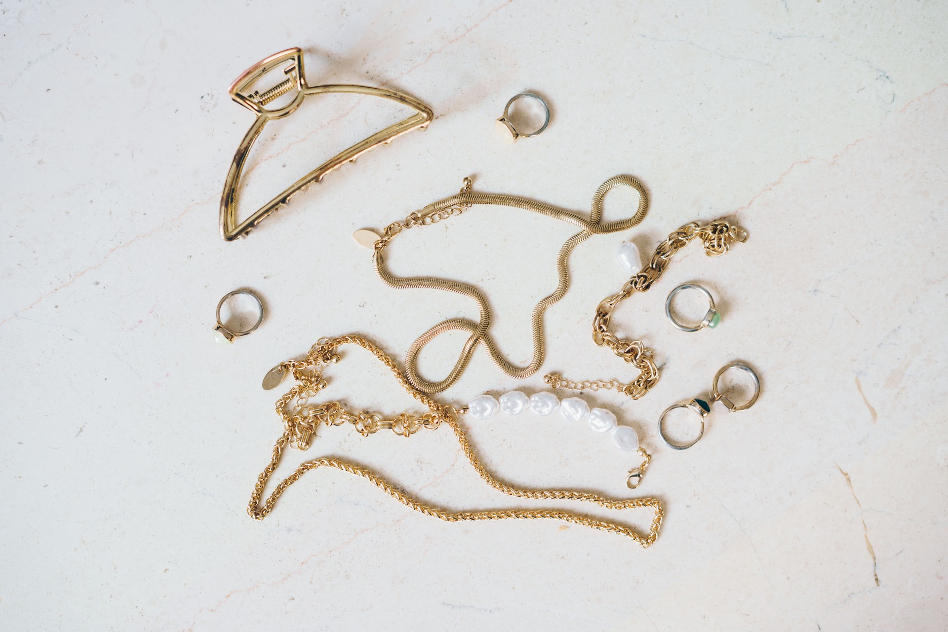 Gold jewellery on a marble surface